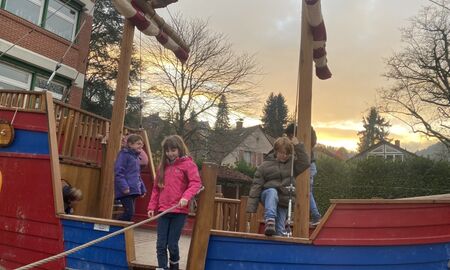 Kinder spielen auf einem großen Piratenschiff auf einem Spielplatz