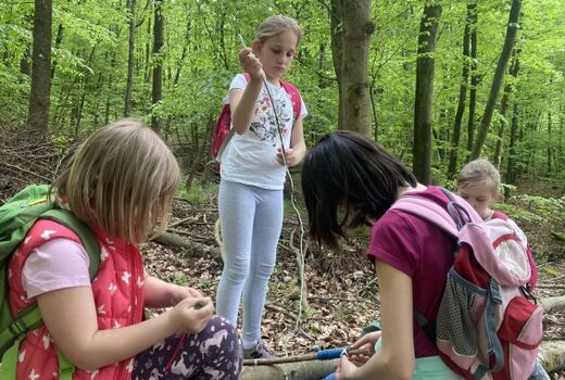 Kinder verzieren Zauberstäbe im Wald