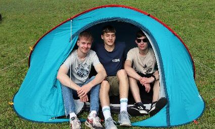Drei Jungs sitzen in ihrem Zelt