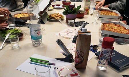 Menschen beim Arbeiten und Pizza essen