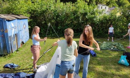 Jugendliche bauen Zelte auf