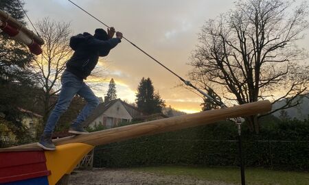 Ein Junge läuft auf dem Wasserstag eines Piratenschiffes. Es dämmert bereits