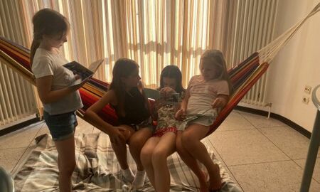 Vier Mädchen sitzen in der Hängematte