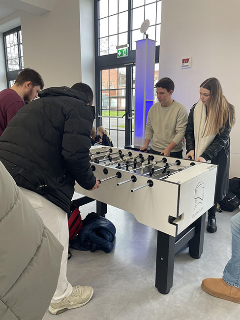 Weitere Schülerinnen und Schüler spielen gemeinsam Tischkicker.