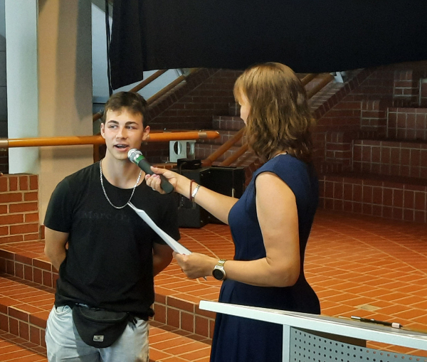 Sebastian Groß nimmt sein Zeugnis von Frau Soerensen entgegen.
